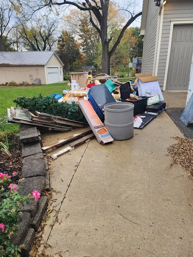 Dumpster being loaded with debris for Estate Cleanout Dumpster Rental in Cactus